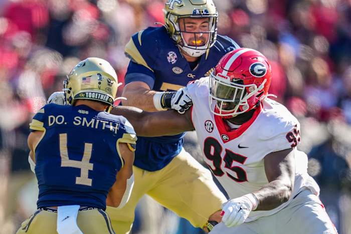 Nov 27, 2021; Atlanta, Georgia, USA; Georgia Bulldogs defensive lineman Devonte Wyatt (95) tries to tackle Georgia Tech Yellow Jackets running back Dontae Smith (4) during the first half at Bobby Dodd Stadium. Mandatory Credit: Dale Zanine-USA TODAY Sports